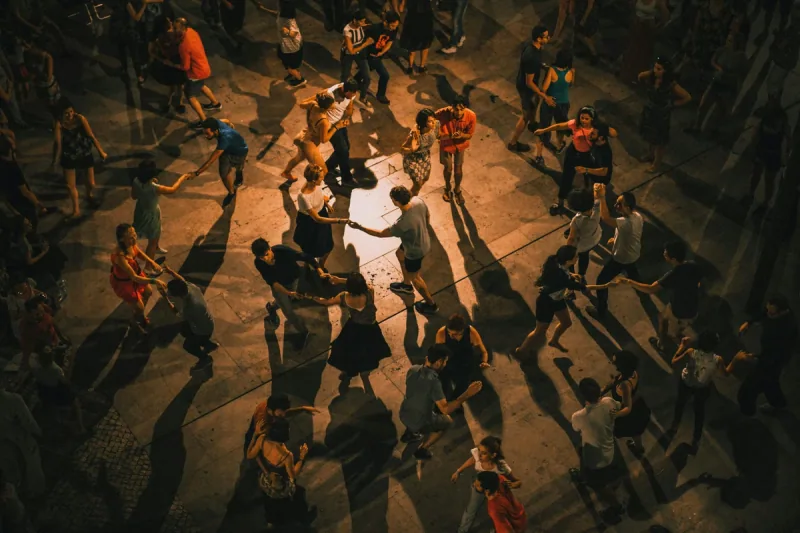 Overhead view of many couples dancing on an outdoor social floor, the social side of bachata dance classes in Ottawa at DQ Ballroom & Fitness