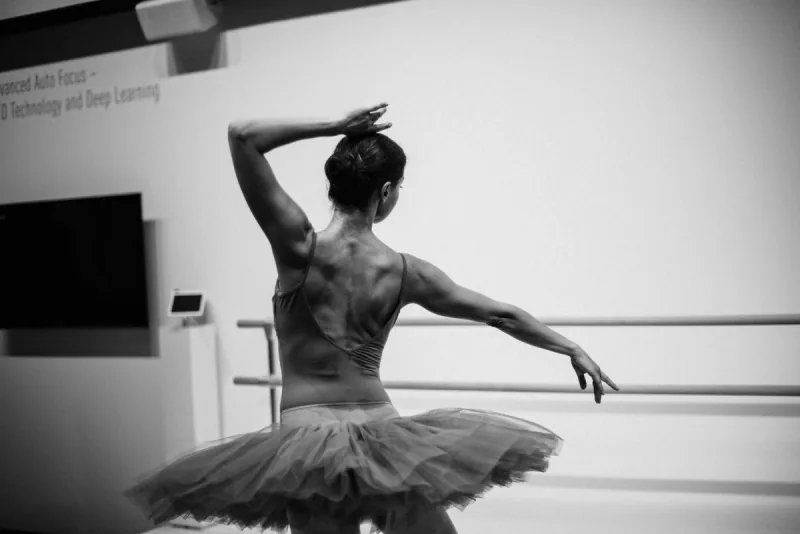 Ballerina in a tutu posing at the barre during a ballet dance class in Ottawa at DQ Ballroom & Fitness