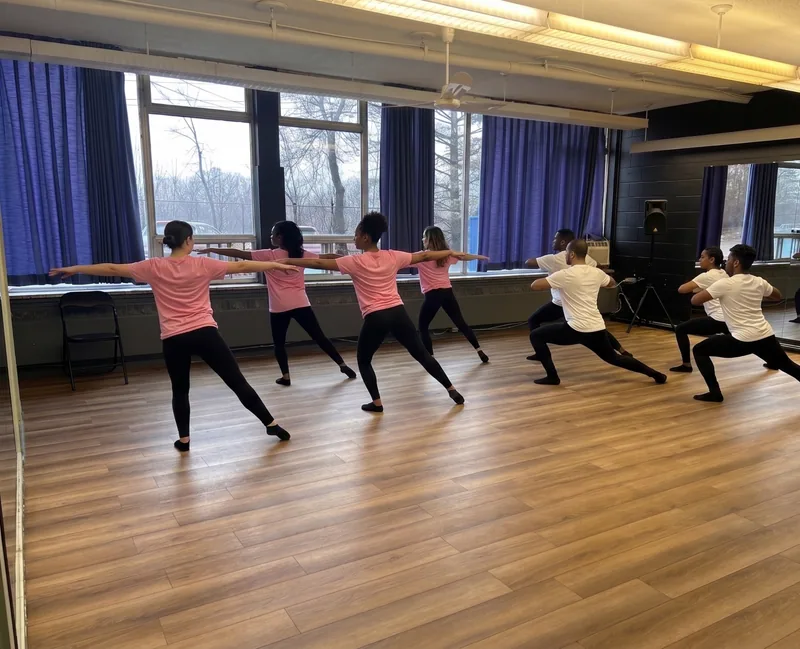 Big Ballroom dance studio rental with hardwood floor and mirrors as a group rehearses lunges in Ottawa