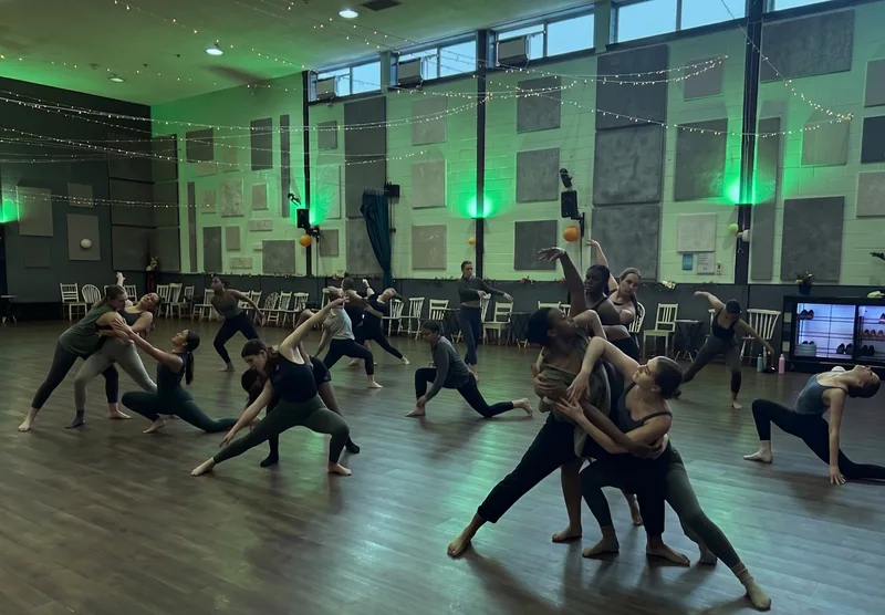 Dancers stretching across a large hardwood floor in an Ottawa dance studio rental room at DQ Ballroom & Fitness