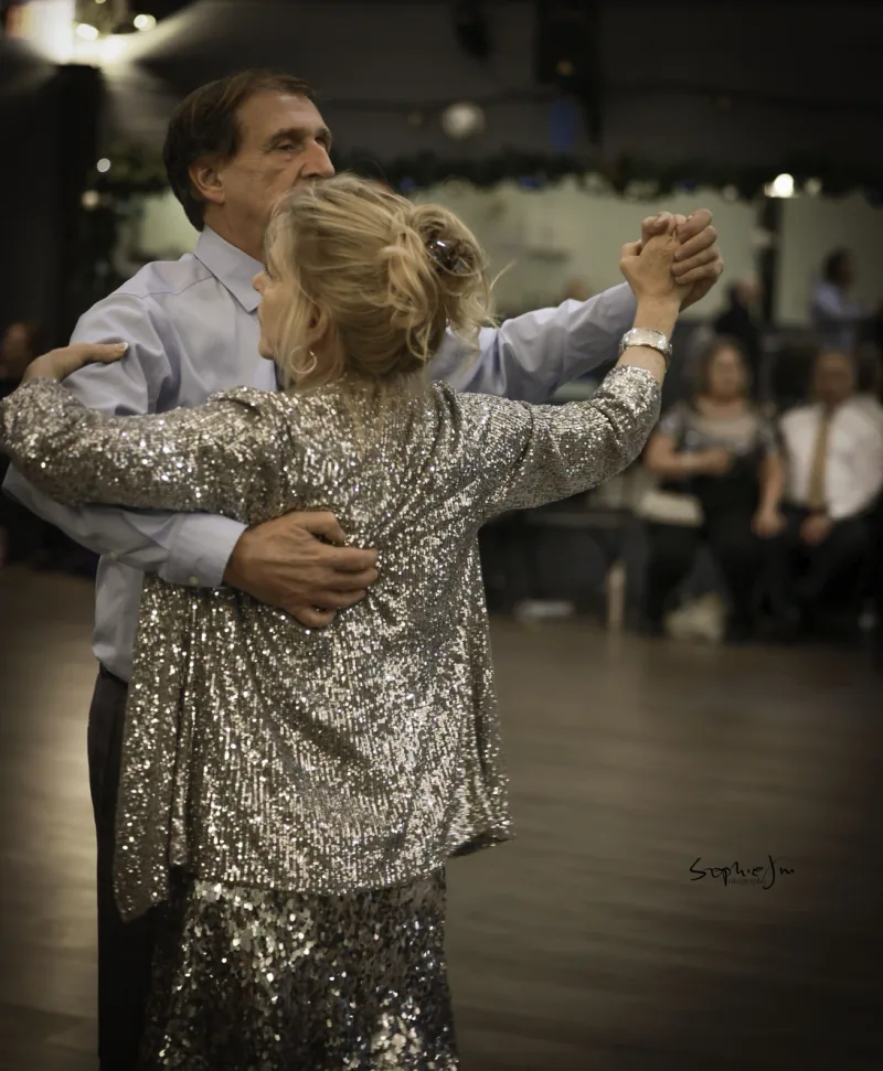 Beginner couples in closed hold across the studio floor during foxtrot dance classes in Ottawa at DQ Ballroom & Fitness