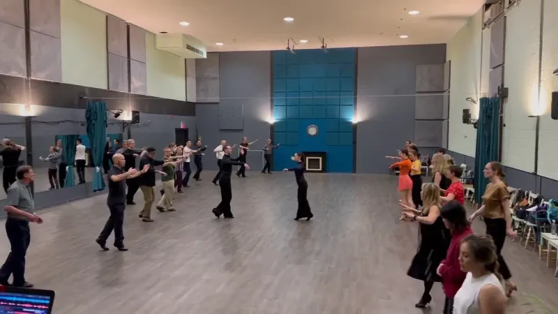 Rows of students following the lead in a group setting during beginner jive dance classes in Ottawa at DQ Ballroom & Fitness