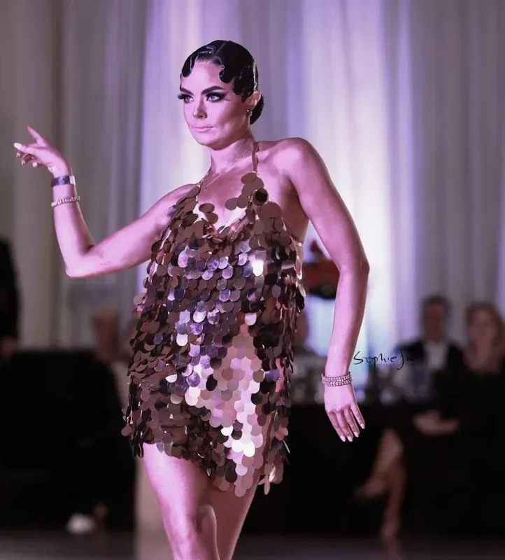 Performer in a sequined dress posing mid-routine, reflecting the lively style of jive dance classes in Ottawa