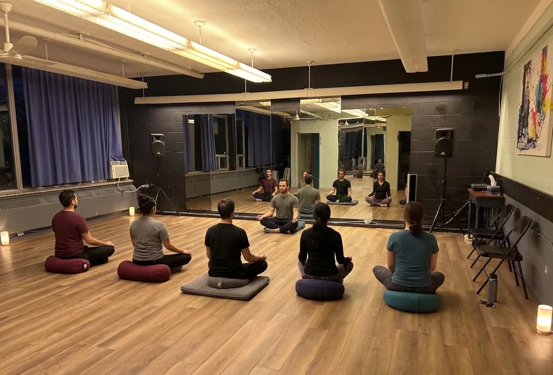 Group seated in a circle for a session in the Ottawa martial arts studio rental space at DQ Ballroom & Fitness
