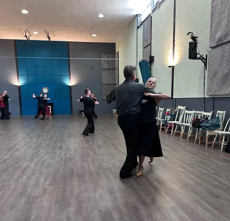 Several couples practicing across the studio floor in a beginner tango dance class at DQ Ballroom & Fitness in Ottawa