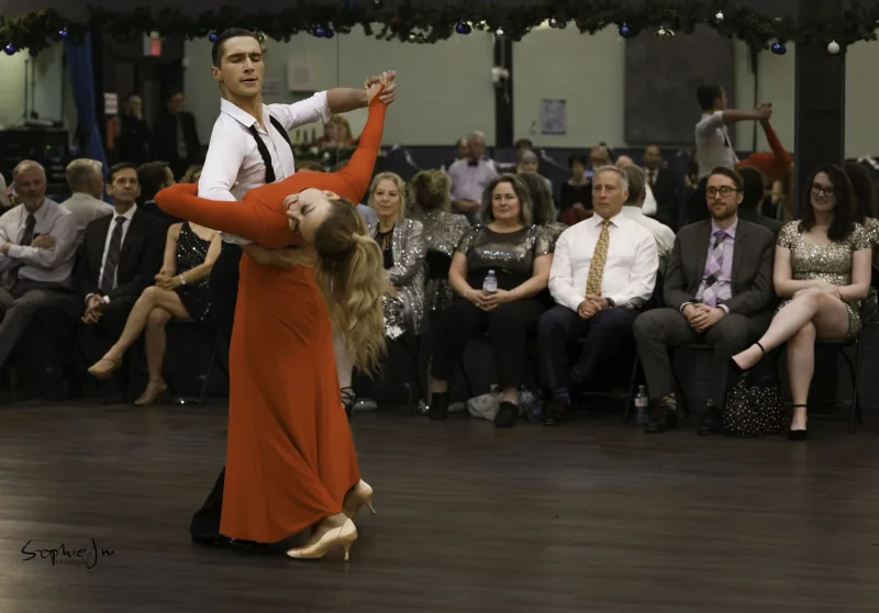 Couple performing a deep backbend pose before an audience, the kind of move taught in tango dance classes in Ottawa at DQ Ballroom & Fitness