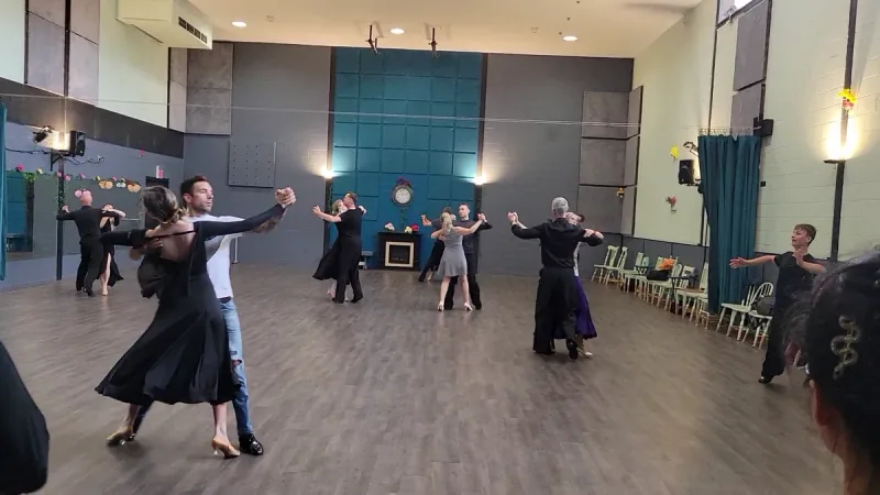 Several couples turning together on the studio floor during Viennese waltz dance classes in Ottawa at DQ Ballroom & Fitness