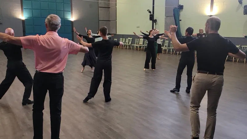 Students practising arm lines in an intermediate Viennese waltz dance class in Ottawa at DQ Ballroom & Fitness
